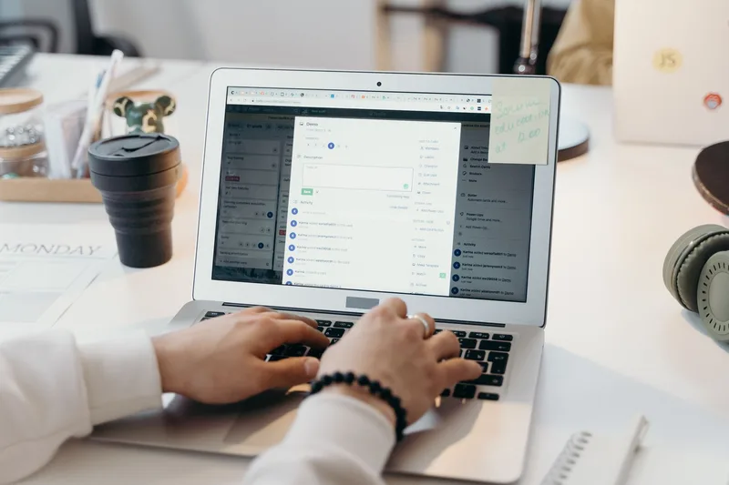 Creator setting up an email list and subscriber follow button on a laptop in a bright workspace