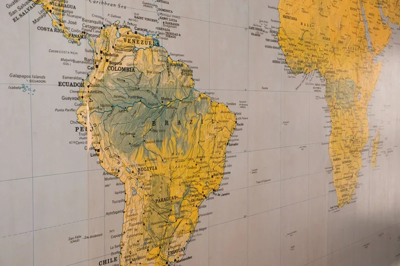 Close-up of a world map, representing the cross-border tax compliance that a merchant of record handles on a seller’s behalf